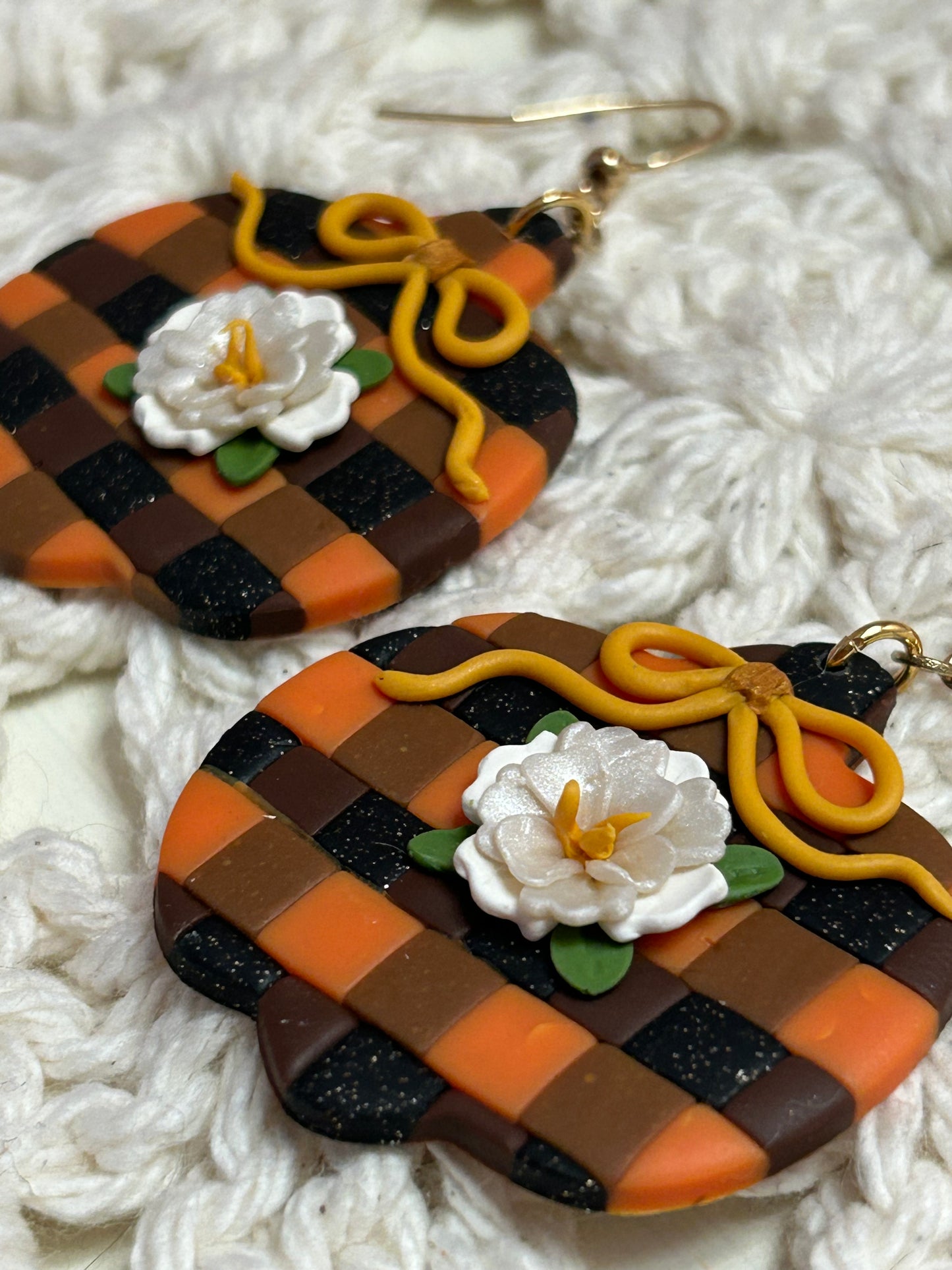 Plaid pumpkin with a white flower