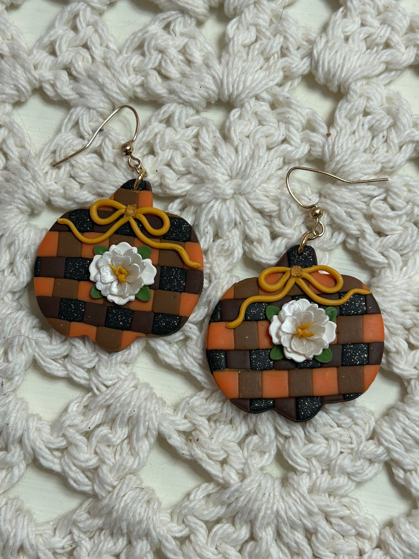 Plaid pumpkin with a white flower