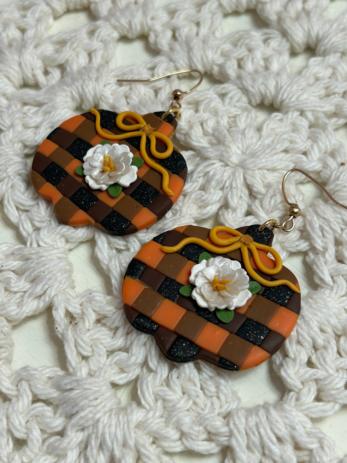 Plaid pumpkin with a white flower